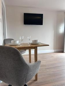 a dining room table with two chairs and a television at Meadow View in Birr