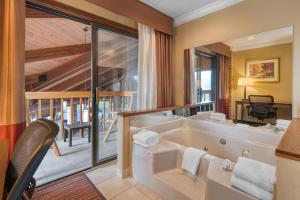 a large bathroom with a tub and a balcony at Best Western Sycamore Inn in Oxford