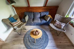 a living room with a couch and chairs and a table at Cherry garden Cseresznyéskert Vendégház in Dunabogdány +13 photos
