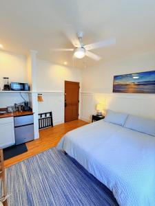 a bedroom with a bed and a ceiling fan at Hilo Town Inn in Hilo