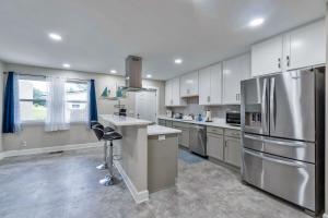 a kitchen with white cabinets and stainless steel appliances at Hill House- Centrally Located, close to everything in Pensacola