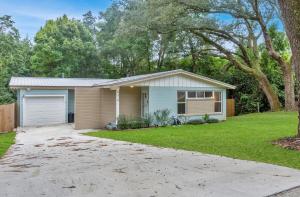 a house with a driveway in front of a yard at Hill House- Centrally Located, close to everything in Pensacola