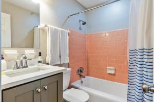 a bathroom with a sink and a toilet and a shower at Hill House- Centrally Located, close to everything in Pensacola +15 photos