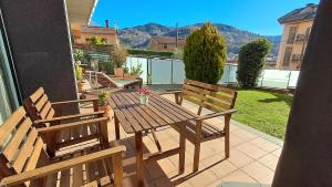 a wooden table and two chairs on a patio at Unique and special loft in Sant Joan de les Abadesses