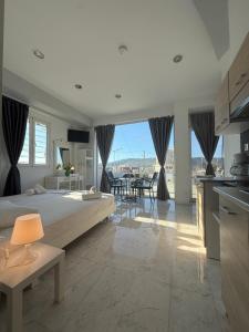 a large bedroom with a large bed and a kitchen at Nova marine 5 in Souda