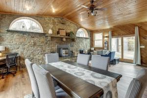 a dining room with a table and a stone wall at Great for Groups! Spacious Melcroft Home w/ Deck in Melcroft