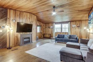 a living room with a couch and a fireplace at Great for Groups! Spacious Melcroft Home w/ Deck in Melcroft