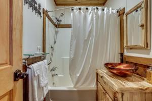 a bathroom with a shower and a sink and a tub at Great for Groups! Spacious Melcroft Home w/ Deck in Melcroft +18 photos
