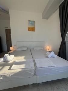 two large white beds in a white room at Nova marine 5 in Souda +3 photos