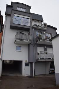 an apartment building with balconies and a parking lot at Chez igor in Pétange