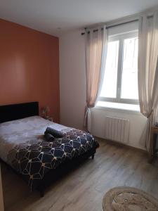 a bedroom with a bed and a large window at Jardin De La Sagesse in Sotteville-lès-Rouen