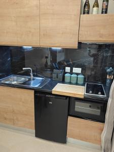 a kitchen with a sink and a counter top at Ta'Roza Modern Apartment with Balcony & Distant Sea Views - Xaghra Gozo in Xagħra
