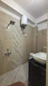 a bathroom with a sink and a toilet in it at Hotel M Palace Unit Of MDP Ayodhya Near Rammandir in Ayodhya