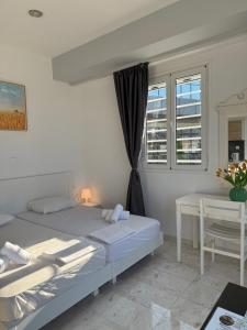 a bedroom with two beds and a window at Nova marine 5 in Souda