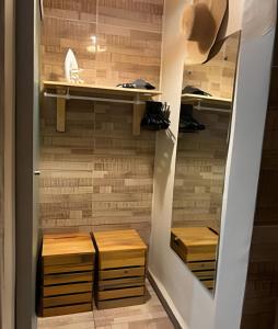 a walk in closet with wooden drawers and shelves at Sua Casa em Noronha - Conforto e Charme na Pousada da Iris in Fernando de Noronha +63 photos