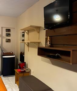 a living room with a flat screen tv on a wall at Sua Casa em Noronha - Conforto e Charme na Pousada da Iris in Fernando de Noronha