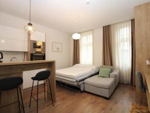 a room with a bed and a couch and a chair at Vila Alexandra in Sarajevo