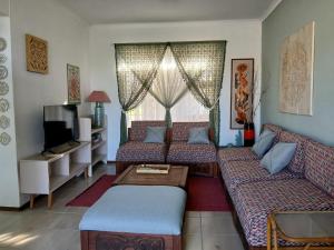 a living room with two couches and a tv at Turtle's Nest in Margate