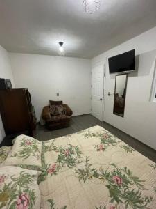 a bedroom with a bed and a flat screen tv at Oaxaca Express, comodidad y cercania al centro in Santa Lucía +16 photos