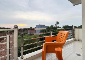 a orange chair sitting on top of a balcony at Hotel Radha Rani palace in Ayodhya