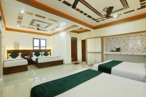 a bedroom with two beds in a room at Hotel Radha Rani palace in Ayodhya