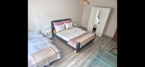 a room with two beds and a mirror and a tub at Apartament Casa Dia Sibiu in Sibiu