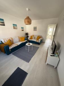 a living room with a couch and a table at Baleal Atlantic View House in Baleal