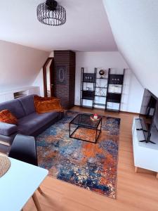 a living room with a couch and a table at Apartment DümmerSee in Hüde