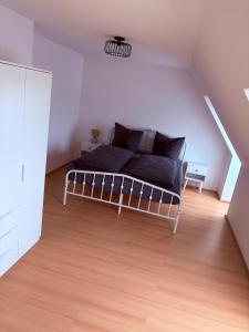 a bedroom with a bed in a attic at Apartment DümmerSee in Hüde