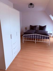 a bedroom with a bed and a large closet at Apartment DümmerSee in Hüde