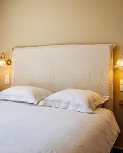 a bed with white sheets and pillows in a room at Juliette in Venaco