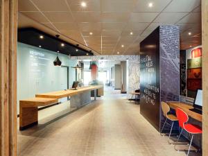a lobby with a bar and chairs in a building at ibis Hyeres Centre in Hyères +118 photos