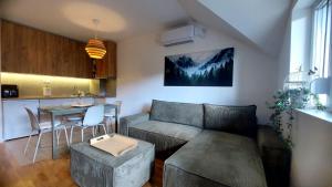 a living room with a couch and a table at My Life 19 - Green Hill in Soko Banja +22 photos