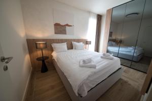 a bedroom with a bed with two towels on it at SkyHill Jahorina Poljice Gondola in Jahorina +5 photos