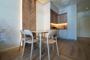 a kitchen and dining room with a table and chairs at SkyHill Jahorina Poljice Gondola in Jahorina