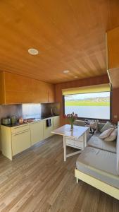 a kitchen and living room with a couch and a table at HappyPlace - Kolpa PremiumMobileHome in Metlika