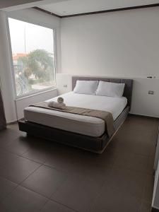 a large bed in a room with a large window at Villa Dreamy Pool Garden in Eilat +12 photos