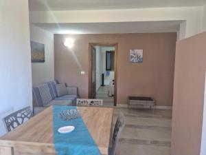 a living room with a table and a couch at Villa Criade in Castelsardo +12 photos