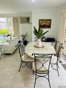 a living room with a table and chairs at ABC Homes Nedlands in Doncaster East