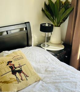 a bed with a pillow with a picture of a woman on it at ABC Homes Nedlands in Doncaster East