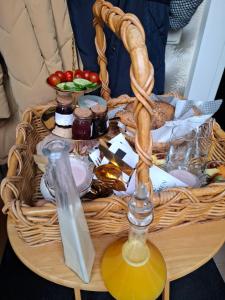 a basket of food on a table with a candle at Dromen op de Veluwe in Putten