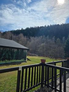 a balcony with a view of a field and trees at Krokusowa Przystań-SPA,Restauracja i Noclegi w Górach Sowich in Rzeczka
