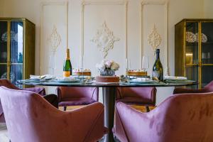 a dining room with a table with two bottles of wine at Palazzo Massimo Boutique Piazza Venezia in Rome +89 photos