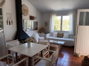 a living room with a table and a couch at Casa Mo in Cala en Bosc