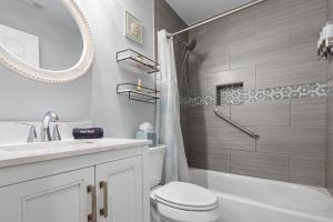 a bathroom with a toilet and a sink and a mirror at Sailors Delight in Beaufort