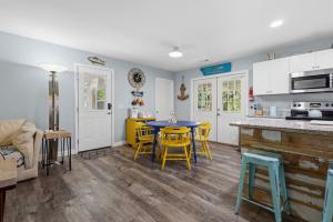 a kitchen and dining room with a table and chairs at Sailors Delight in Beaufort +19 photos