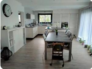 a kitchen with a table and chairs in a room at Maison cosy in Grésy-sur-Aix