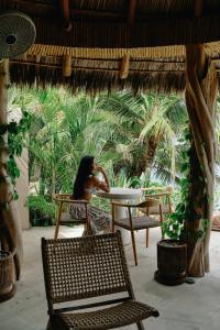 a woman sitting at a table in a patio at La Joya Sayulita in Sayulita