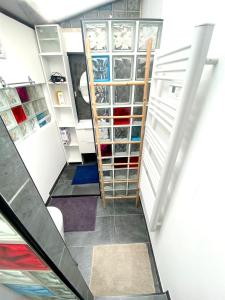 a walk in closet with a ladder and shelves at MataDoora in Nîmes