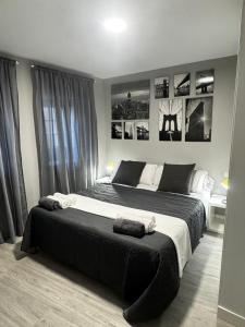 a black and white bedroom with a large bed at PASEO CASCO ANTIGUo in Lugo